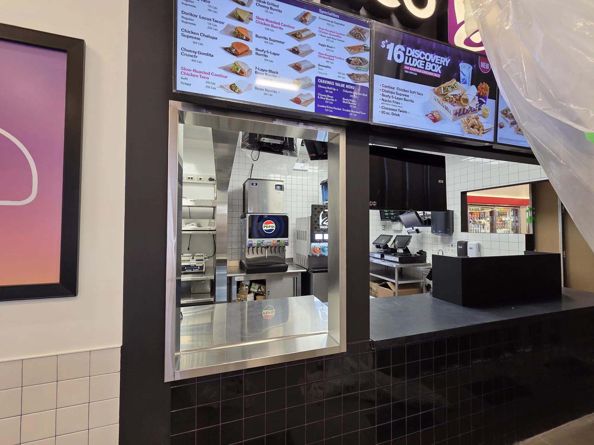 Stainless service window and illuminated menu boards at a completed gas station restaurant build-out in Vaughan