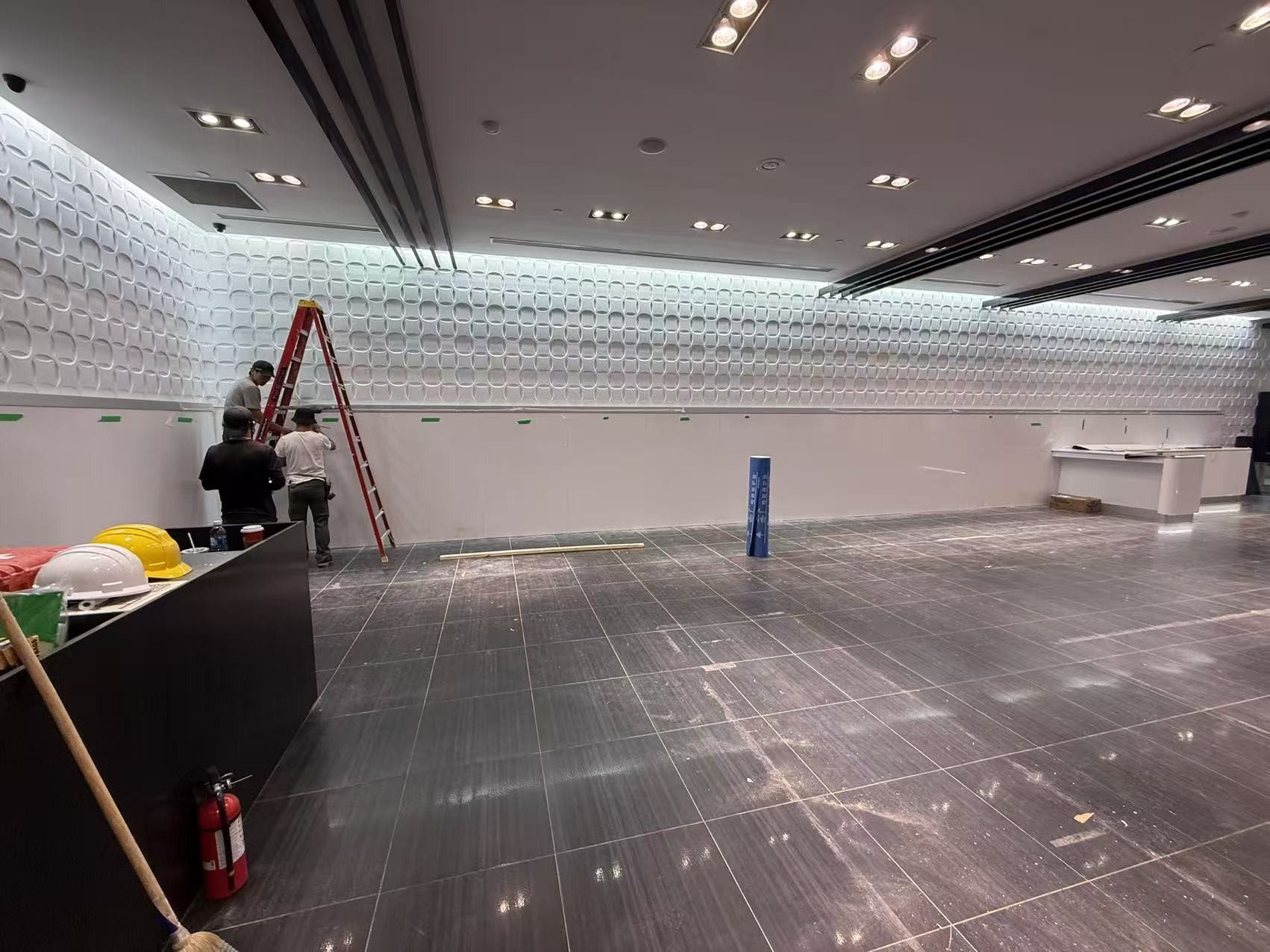 Buildup Contracting crew installing a feature wall on an active commercial jobsite in the GTA