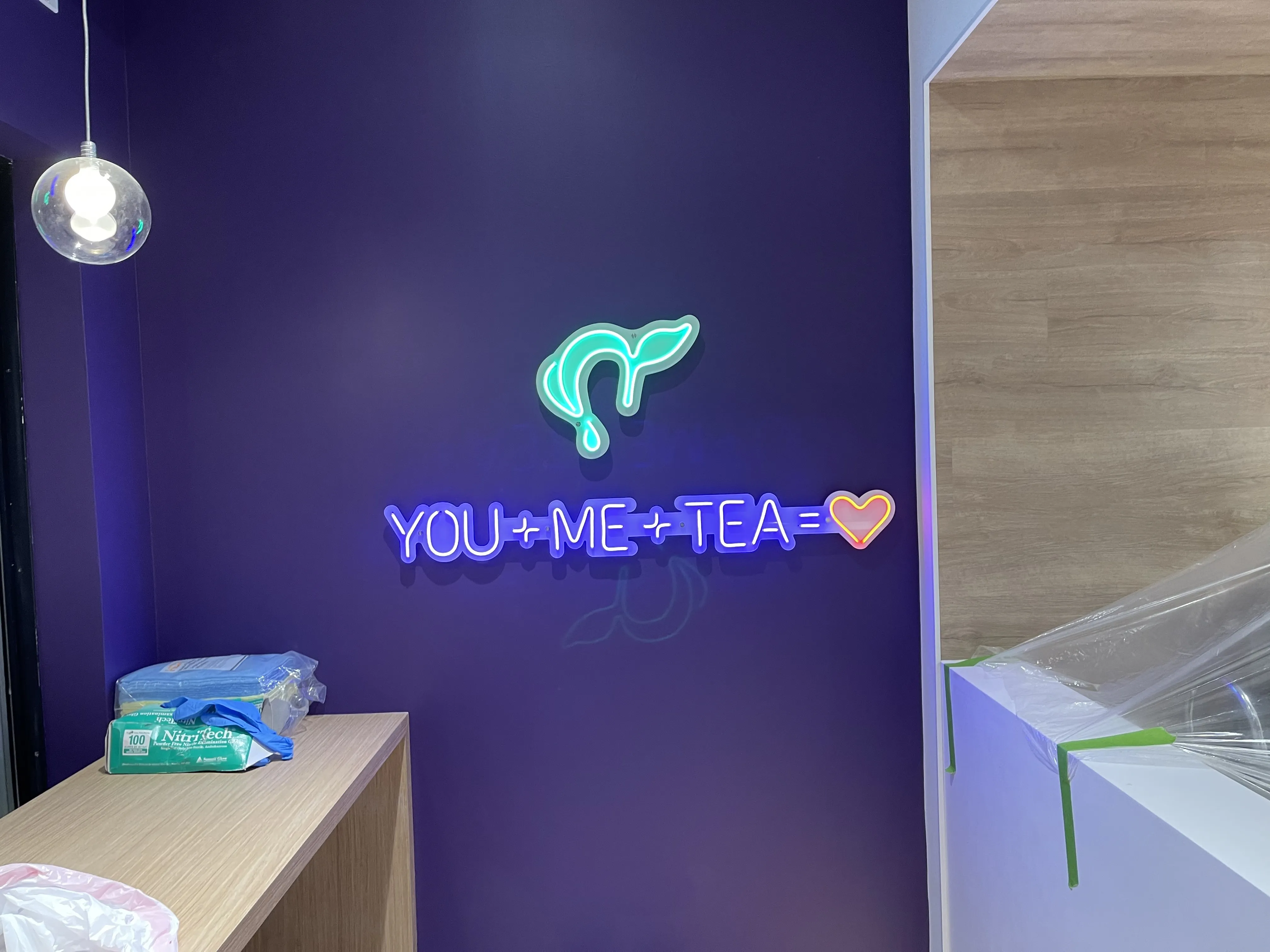 Illuminated brand feature wall built to franchise standards in a GTA restaurant build-out