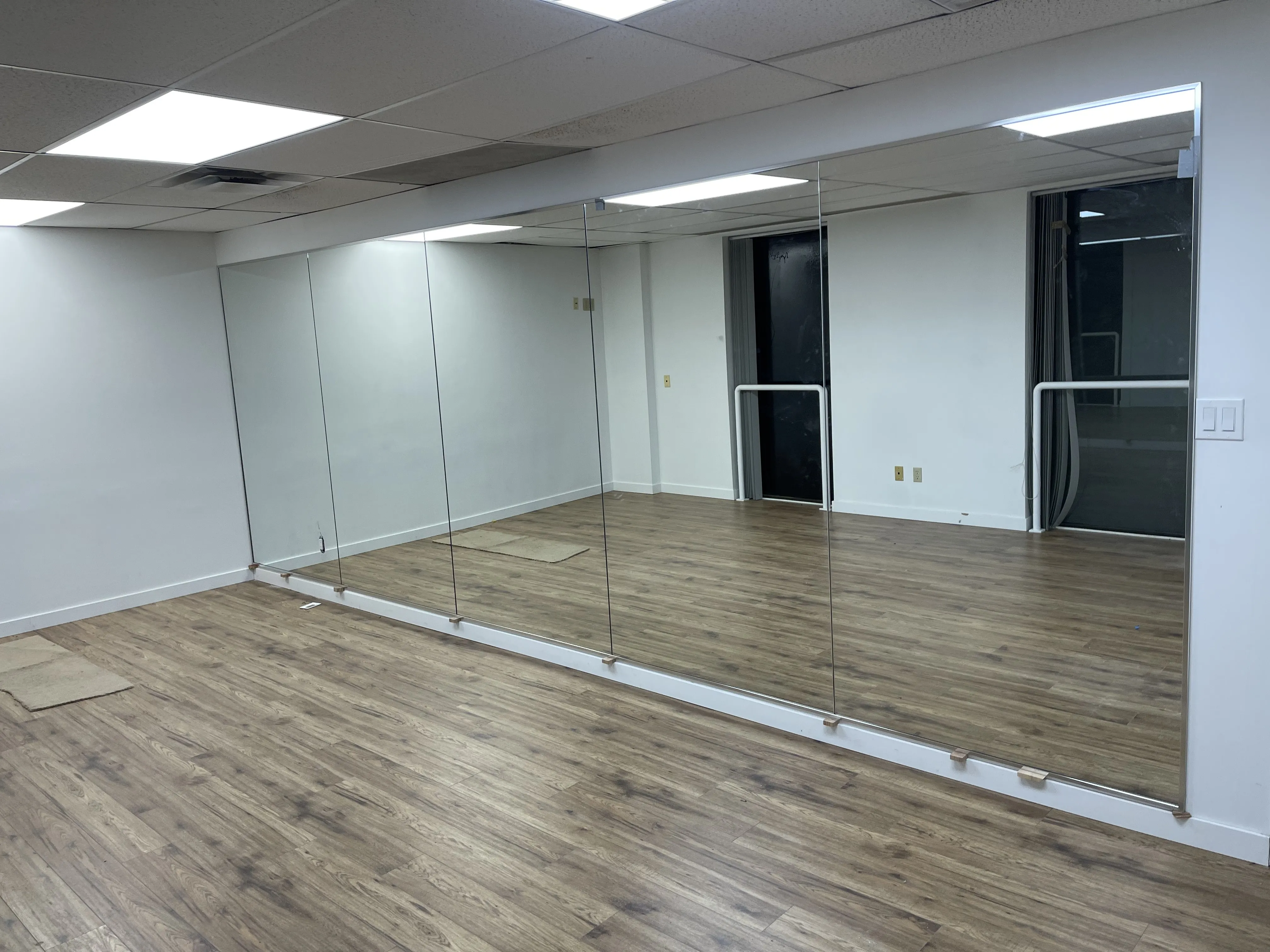Completed office fit-out with glass partitions and new flooring, Toronto & GTA tenant improvement