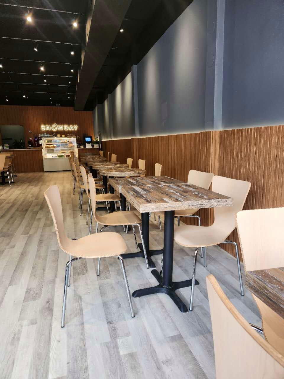 Cafe seating along a wood slat wall in a renovated Toronto dessert shop