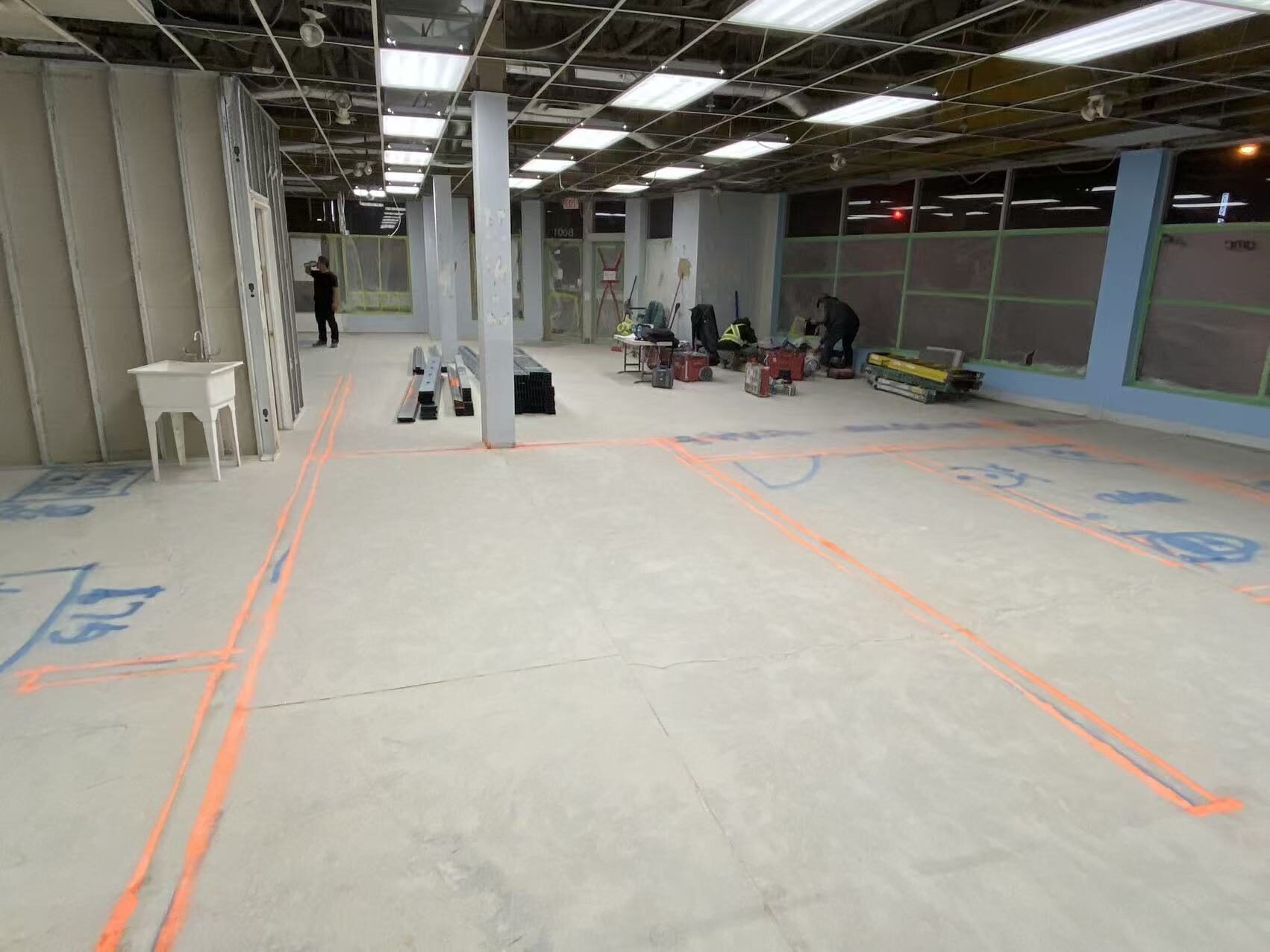 Concrete slab with restaurant layout lines marked out after demolition in a Toronto QSR build-out