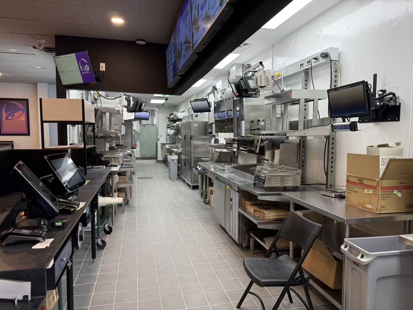 Finished commercial kitchen cook line with stainless equipment in a Toronto quick-service restaurant