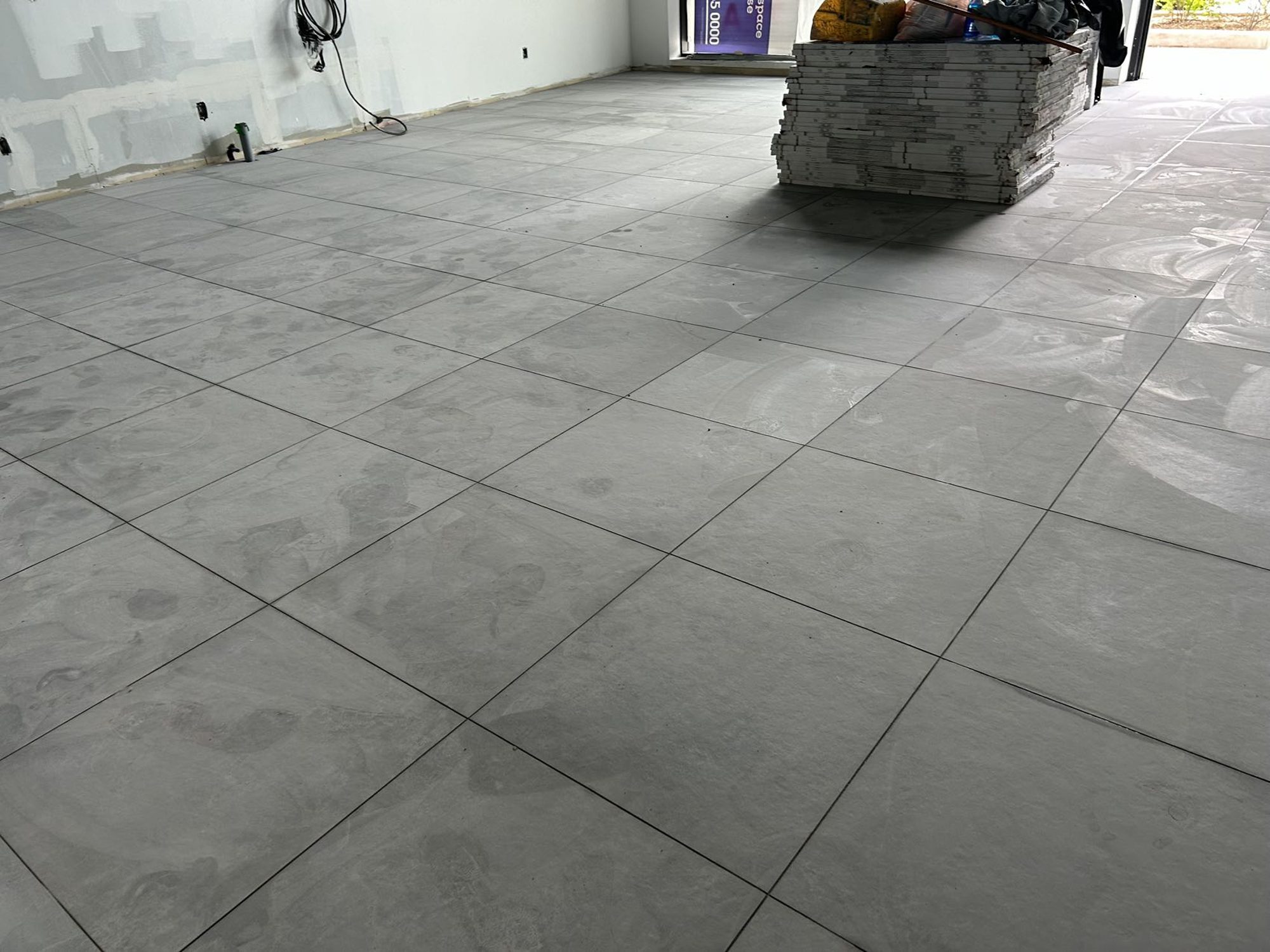 Large-format porcelain floor tile laid through the sales area of a Mississauga bubble tea shop