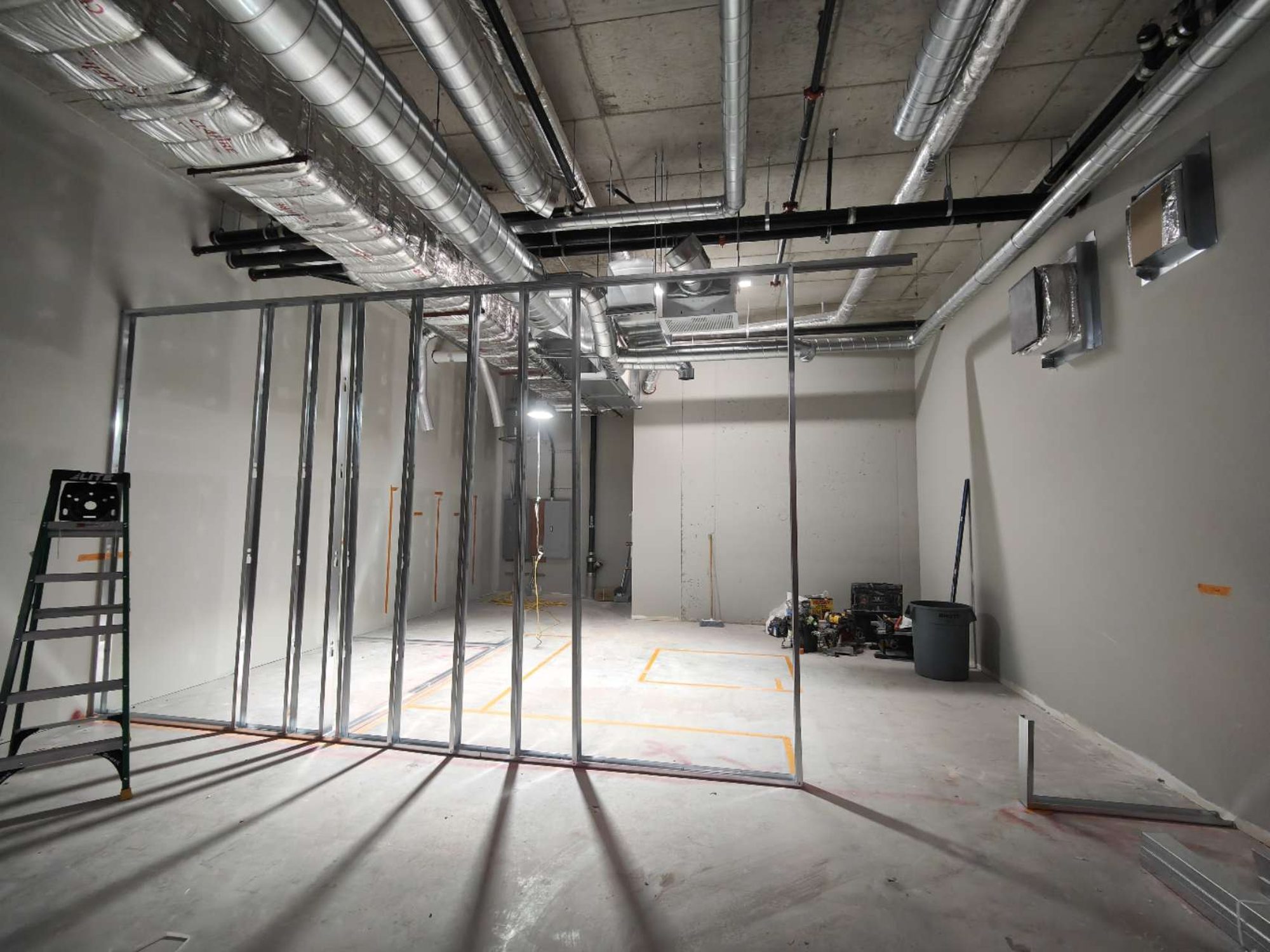 Steel stud partition framing under an open ceiling during a Mississauga bubble tea shop build-out