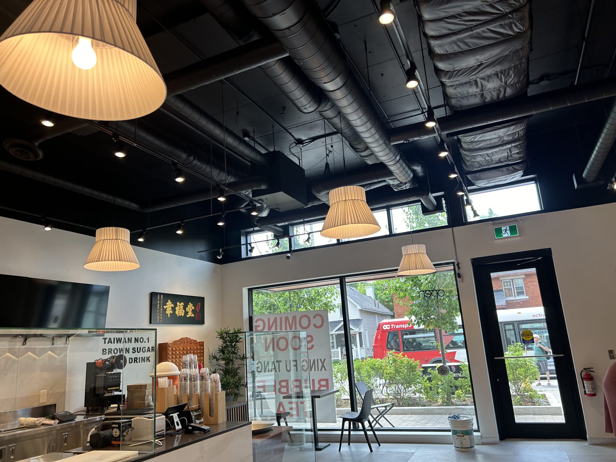 Finished bubble tea shop interior looking toward the storefront glazing in Mississauga