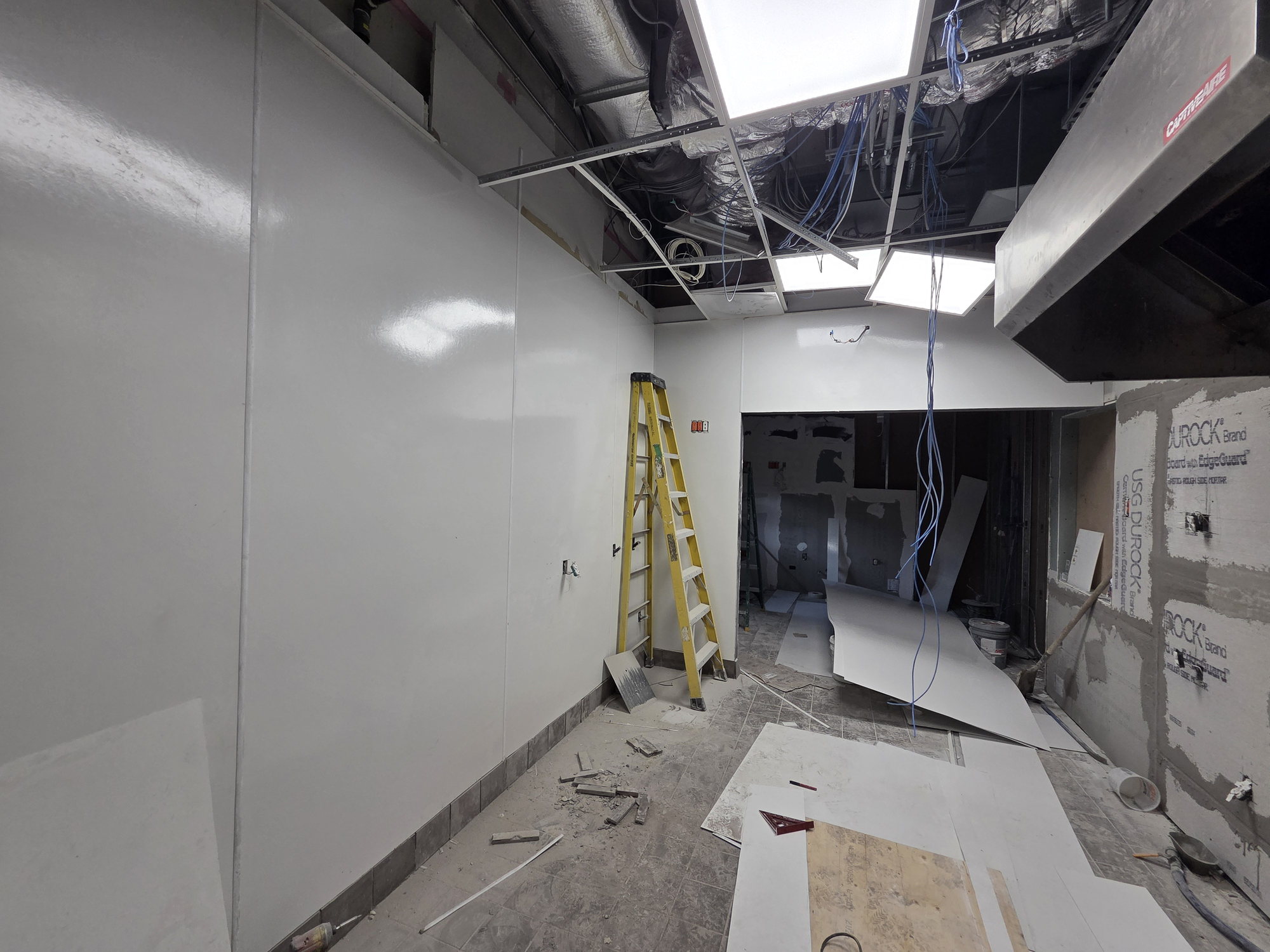 Taped and finished white walls before kitchen equipment install in a Vaughan gas station QSR