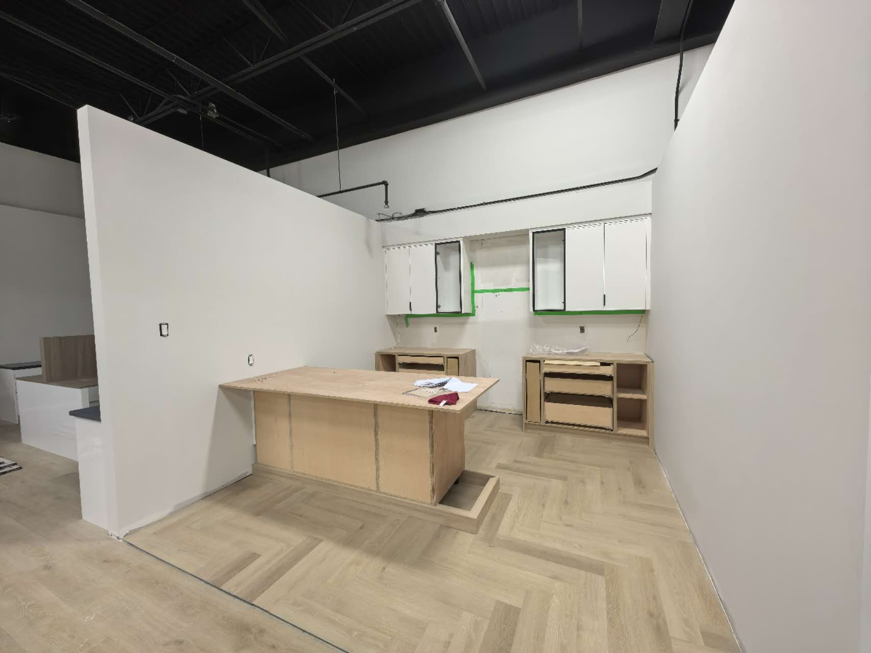 Herringbone flooring display area with millwork counters in an Etobicoke showroom