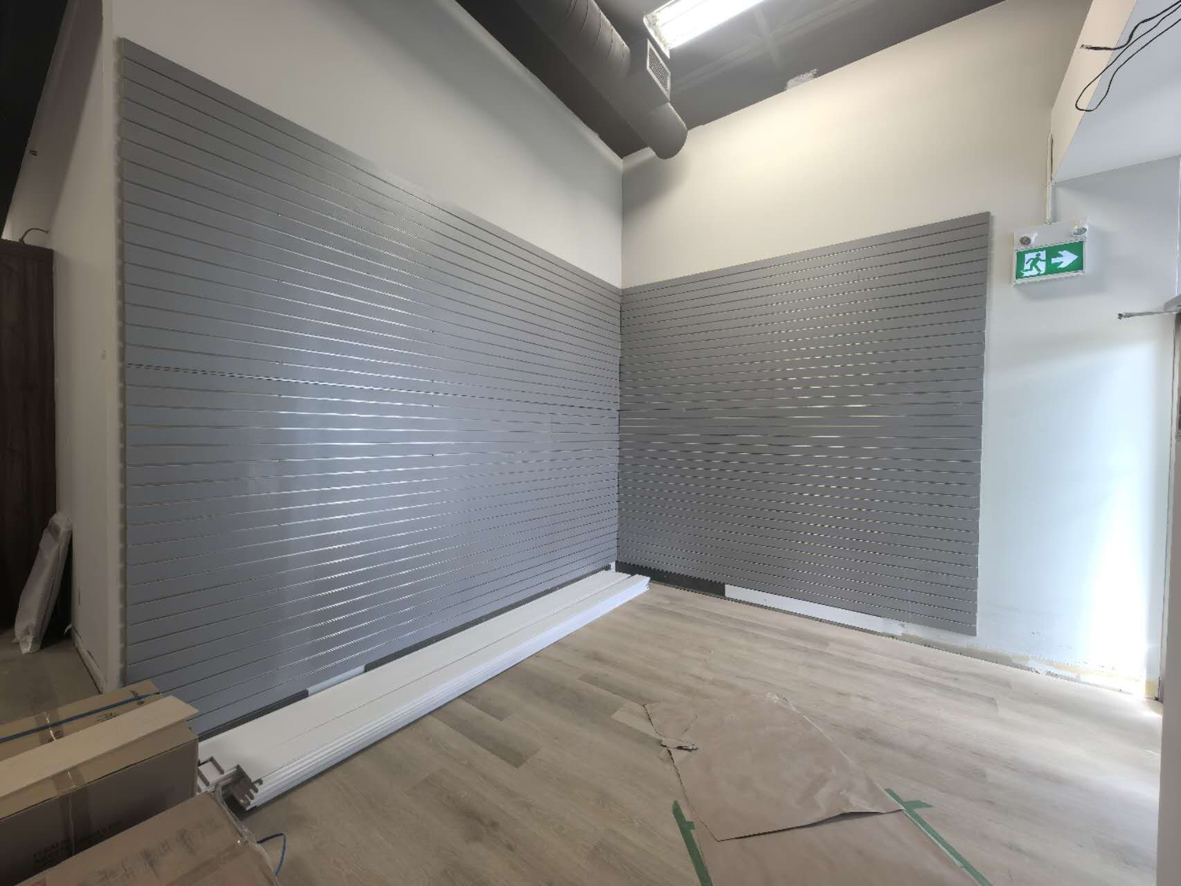 Grey slatwall sample display panels installed in a design showroom in Etobicoke