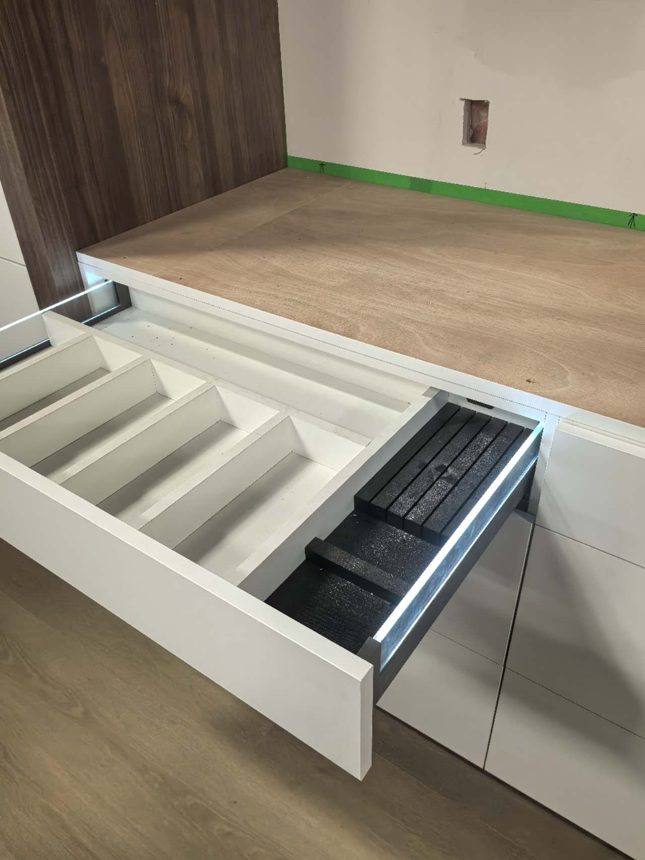 Raised display platform with integrated LED strip and flooring sample drawer