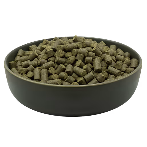 Green bowl filled with small, cylindrical green pellets.