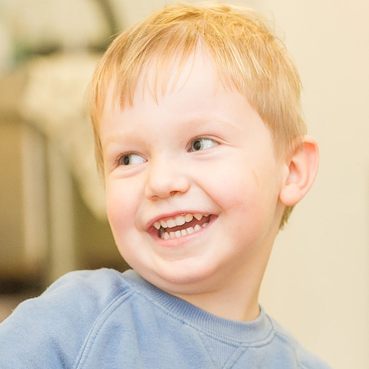 Smiling boy in blue top