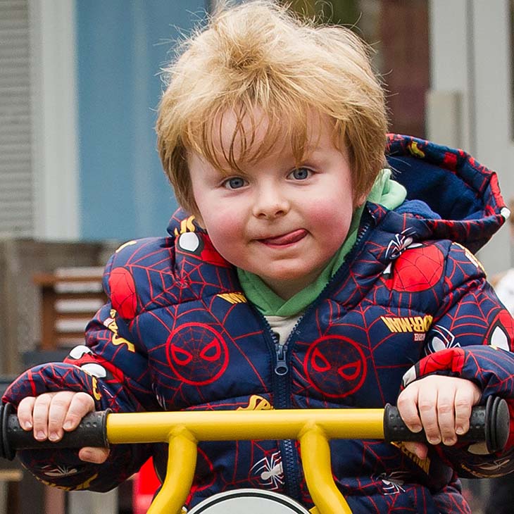 Child riding a tricycle 