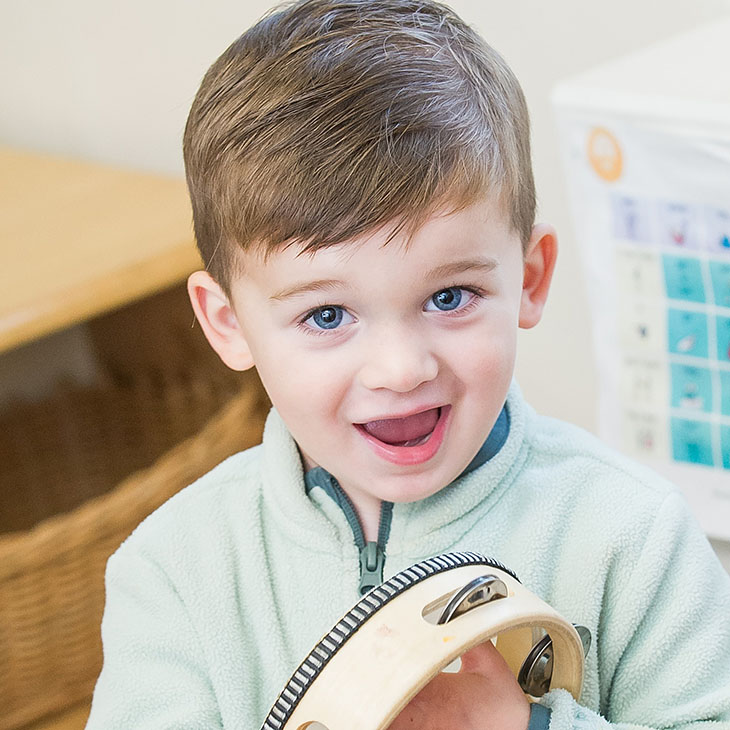 Smiling boy with a tambourine