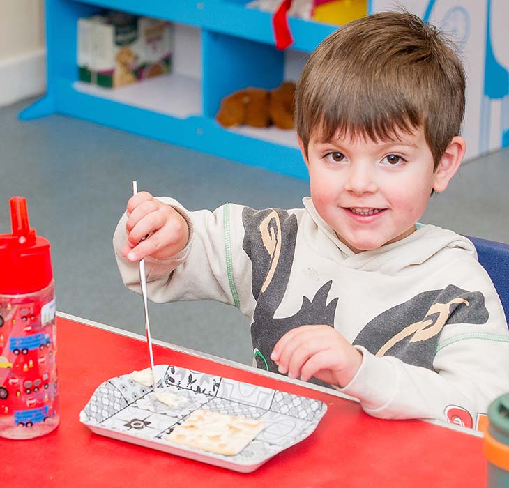 Smiling boy holding a straw