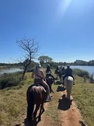 A group riding beside the water.