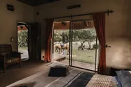 A room with horses just outside the door