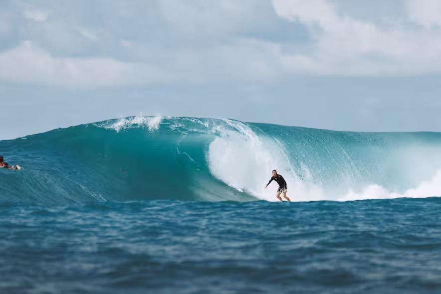 surfer in Bali catching a wave