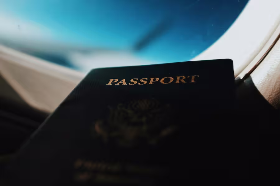 passport on a plane with sky view
