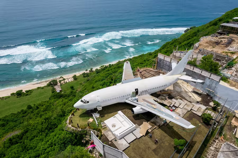 airplane among villas in Bali near ocean