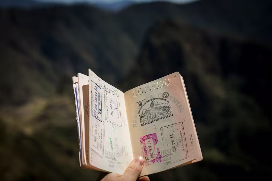 passport with visas in front of mountain view