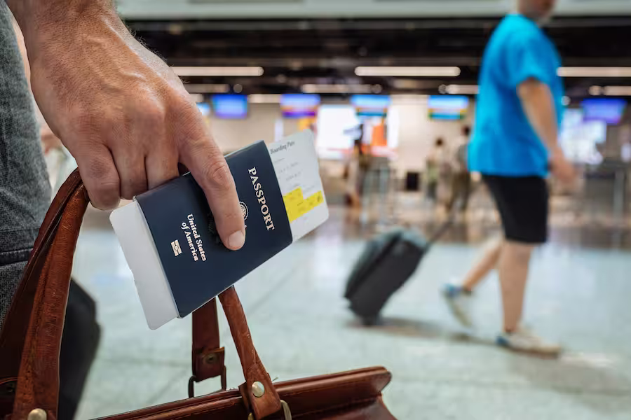 luggage with a passport in a hand in the airport