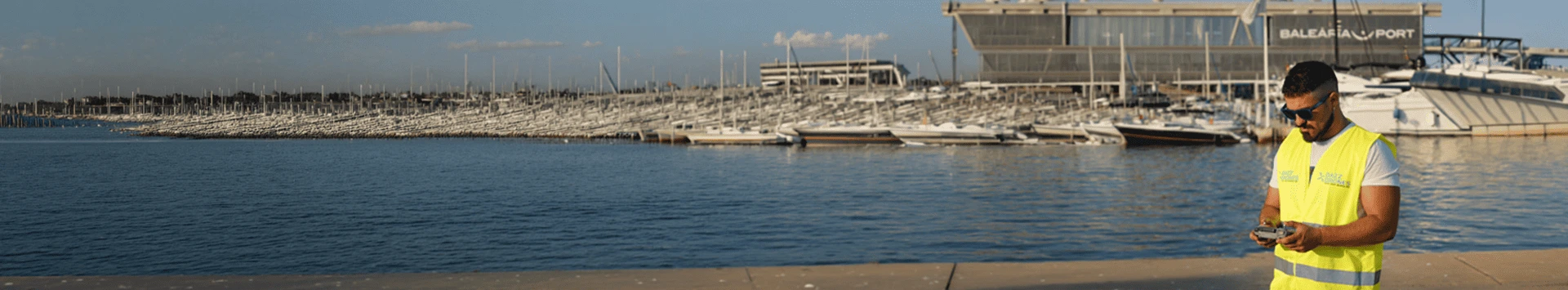 Dazz Drones pilot operating a drone at a marina for maritime aerial photography