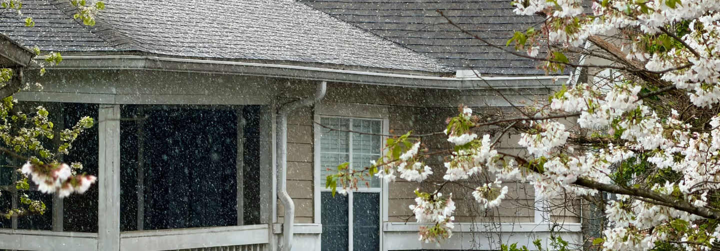 Seamless aluminum gutters effectively diverting heavy rainwater from a roof in Middlesex County to protect the home's foundation.