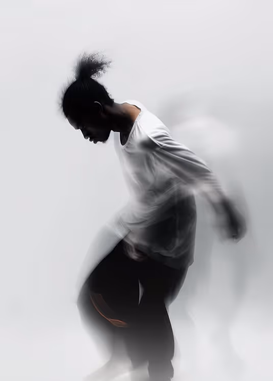Silhouette of a person in motion with blurred arms and legs against a light background.