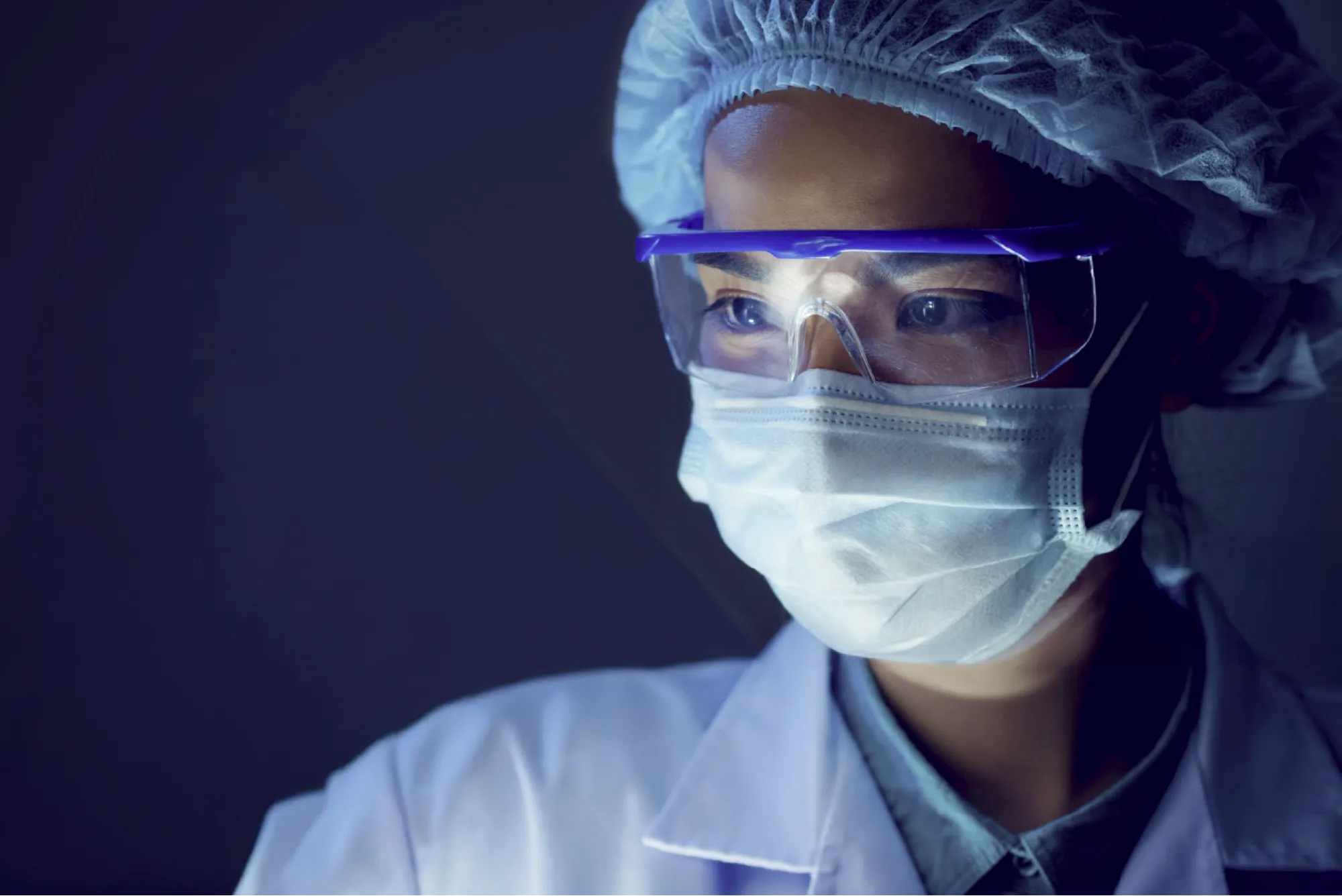 A woman wearing a protective mask and goggles.
