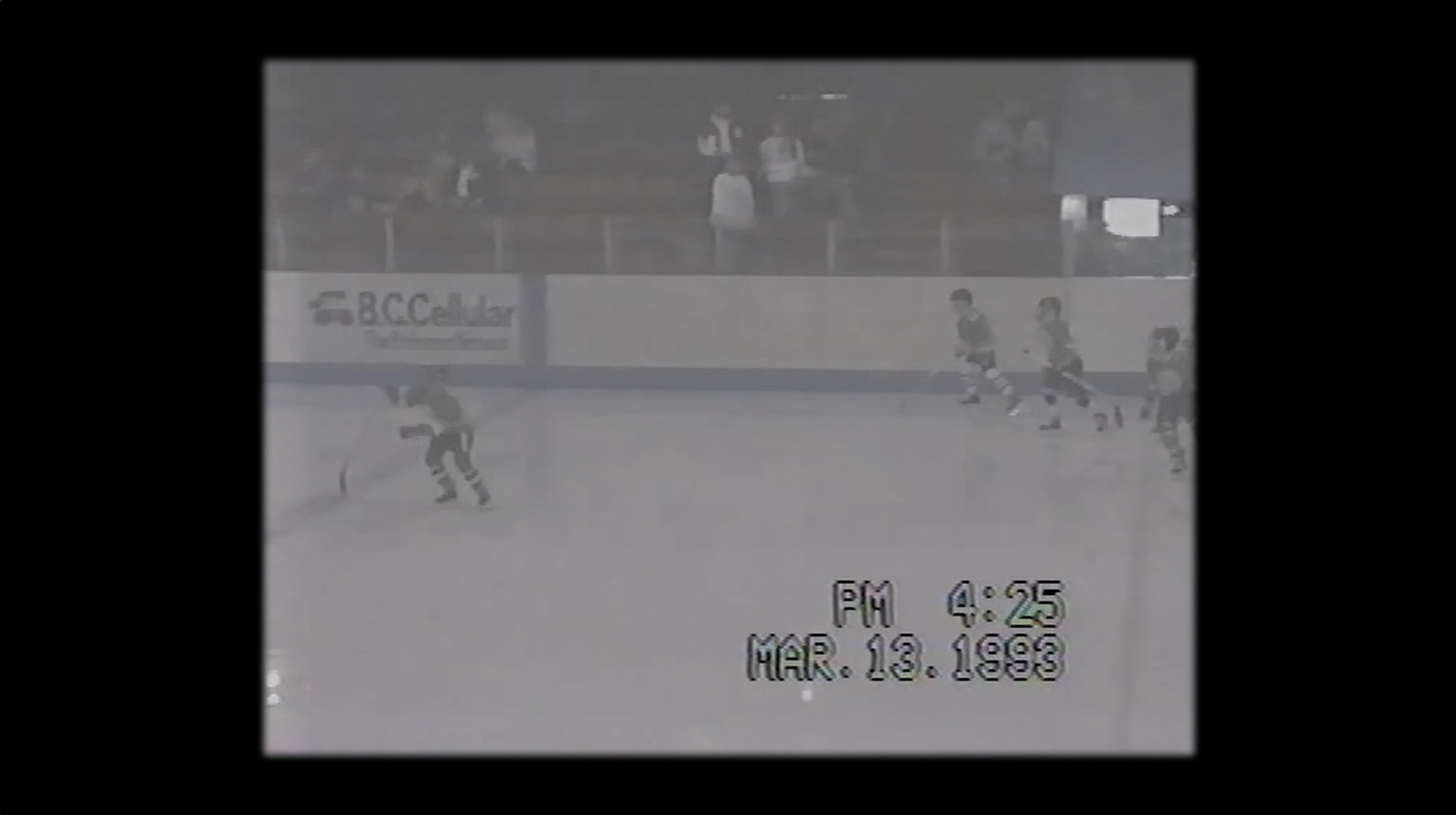 Shot of a television playing a home video of a little league hockey game still image from music video