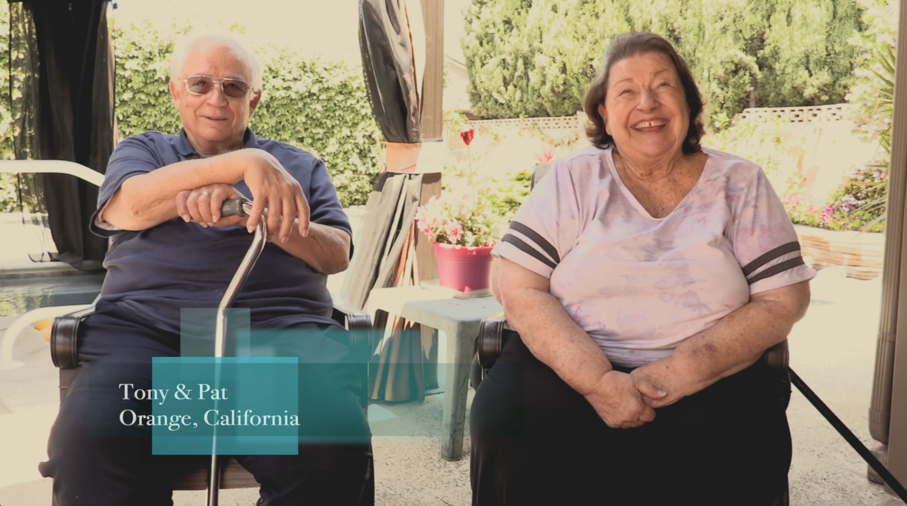 Warm candid portrait of couple seated outdoors in natural cinematic light