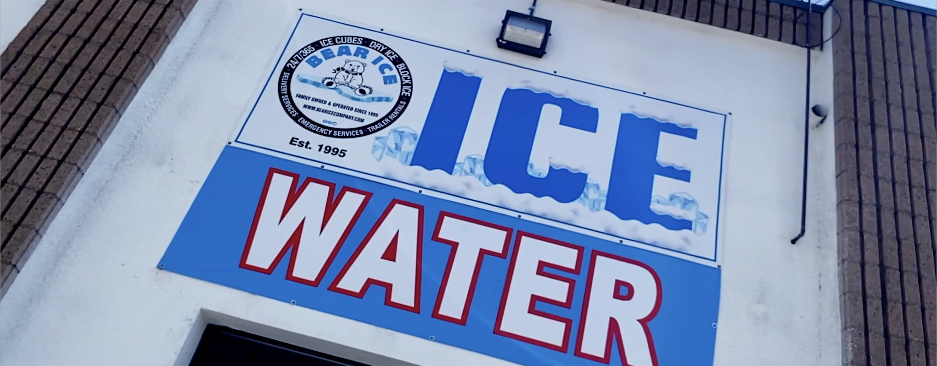Ice water storefront sign photographed in cinematic documentary Dutch angle style