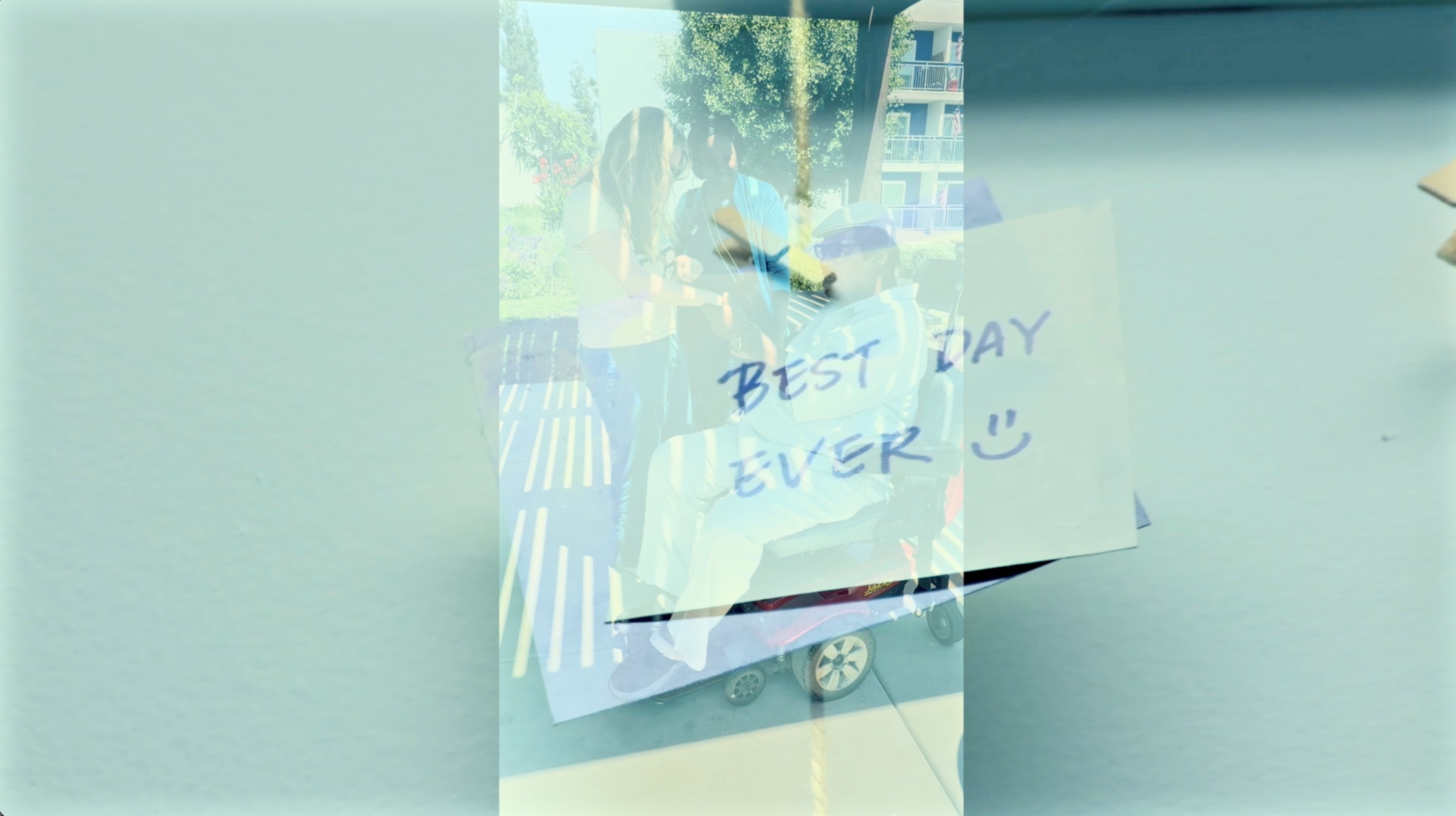 Caregivers shaking hands with client in wheelchair sticky note with Best Day Ever overlaid on image