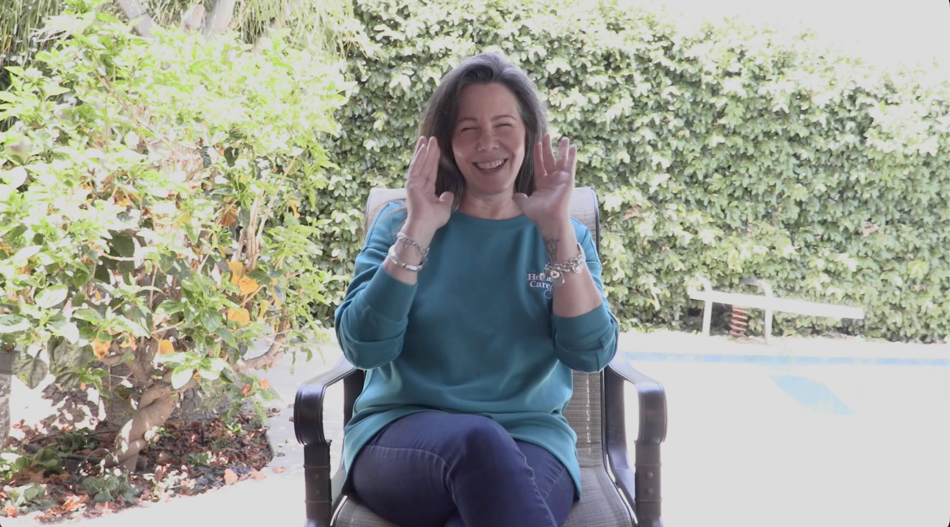 Image from corporate branding of caregiver laughing during interview