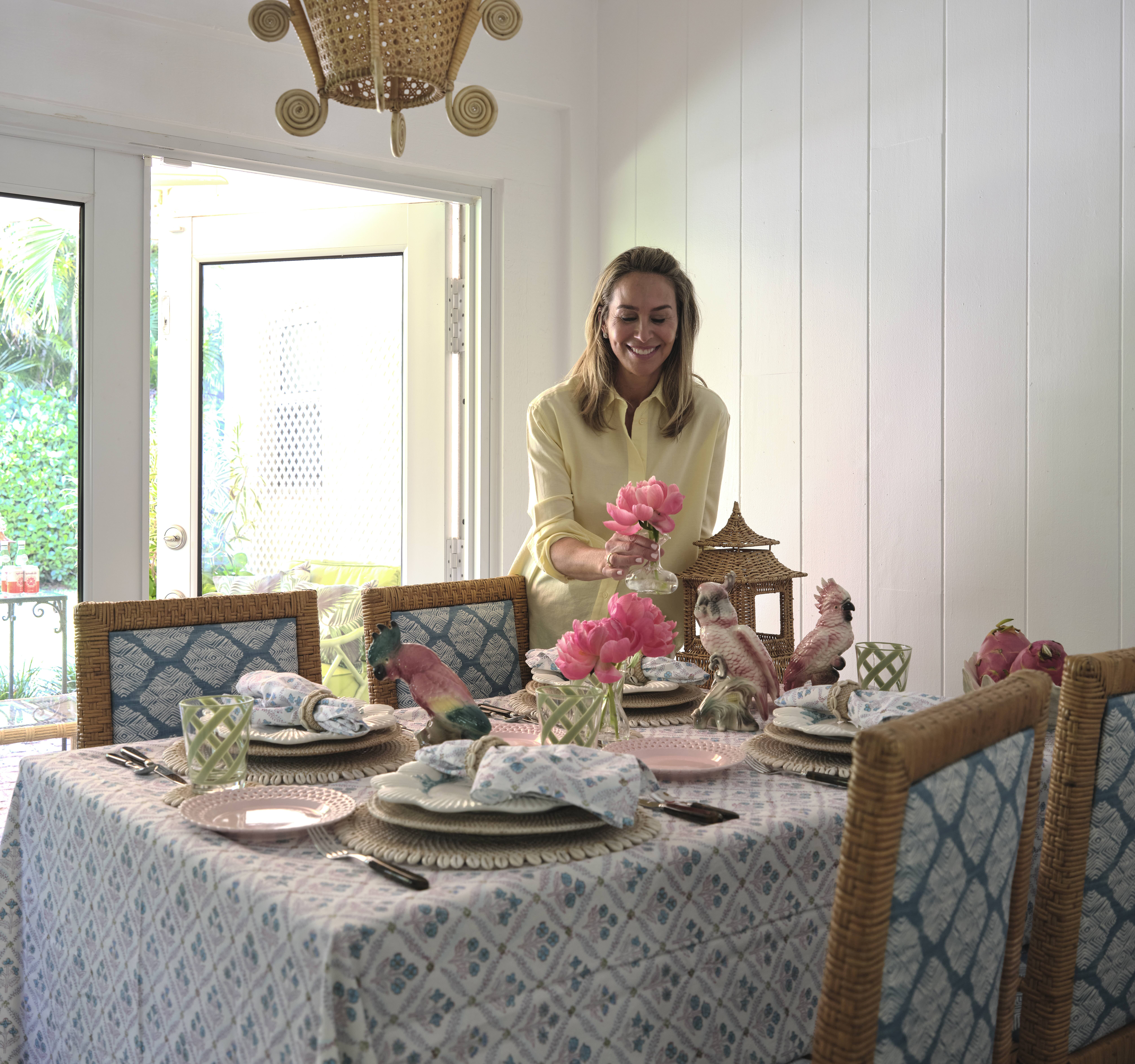 Hillary Thomas arranging peonies at a Palm Beach tablescape