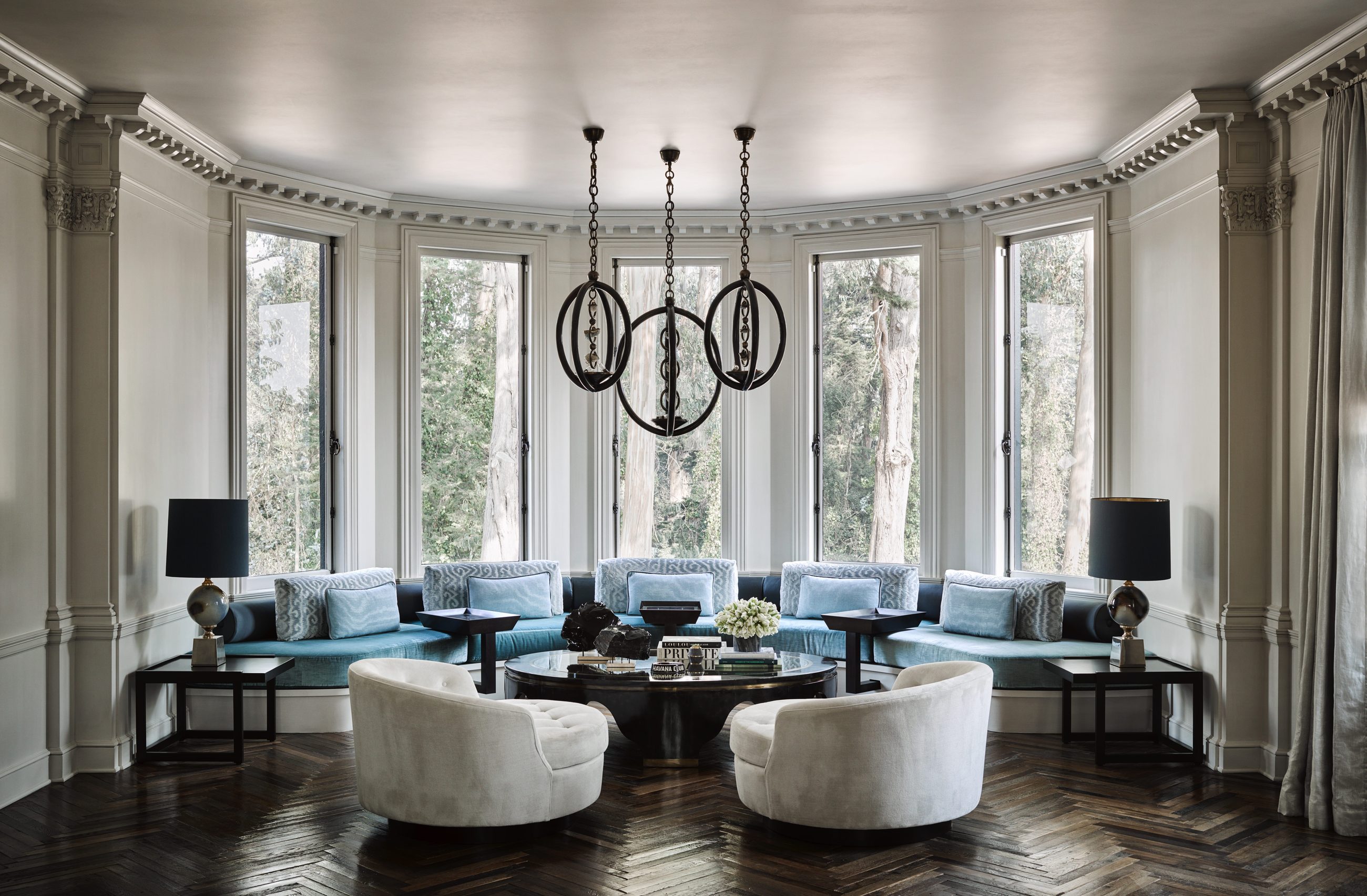 Bay window living room with curved blue banquette