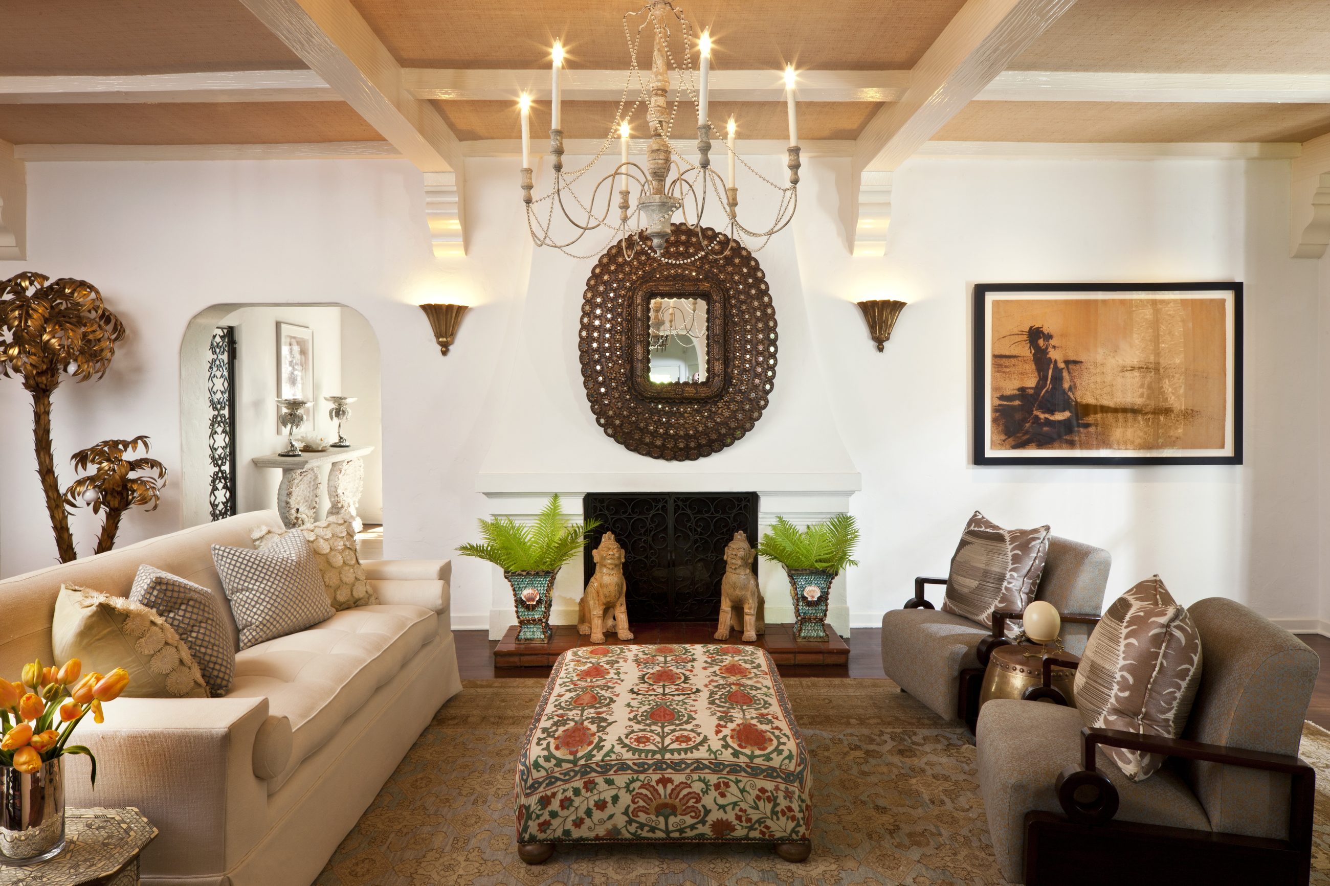 Spanish Mediterranean living room with foo dogs and suzani ottoman