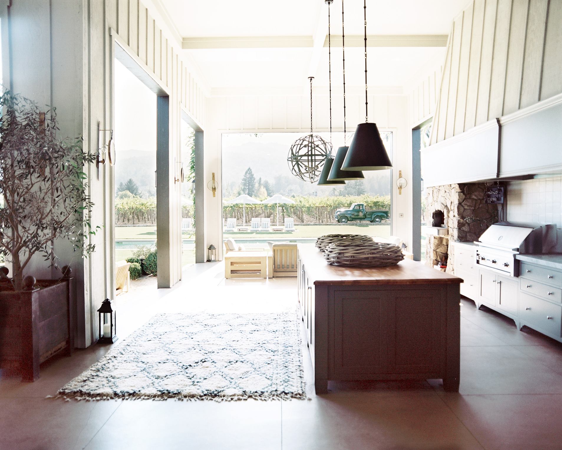 Contento Napa Valley great room kitchen opening to the vineyard by Hillary Thomas