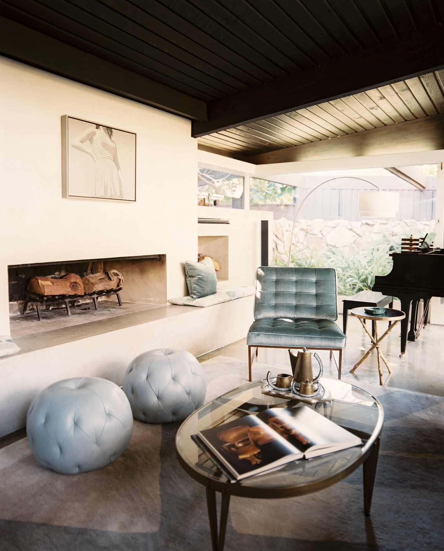 Midcentury Modern Retreat living room fireplace with tufted velvet seating by Hillary Thomas