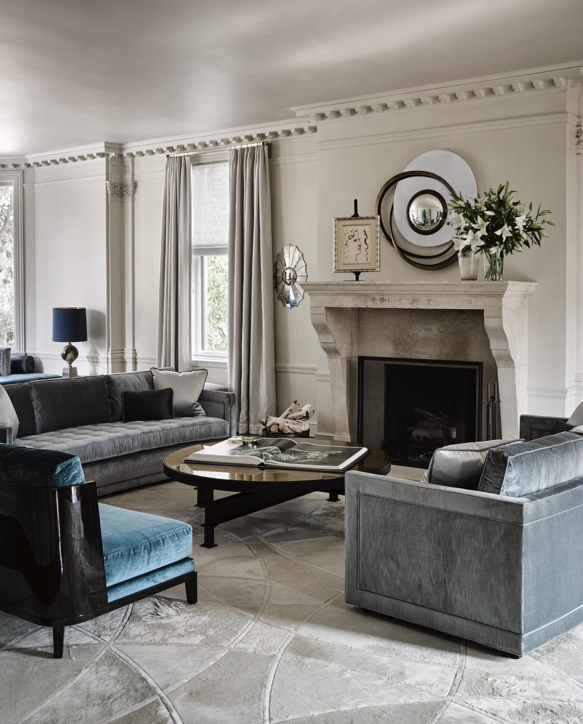 San Francisco Tudor living room with carved stone fireplace by Hillary Thomas