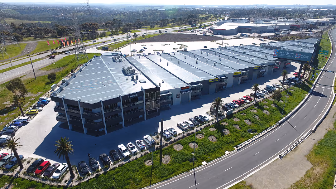 Aerial view of a large sports and entertainment venue with rooftop solar panel installation.