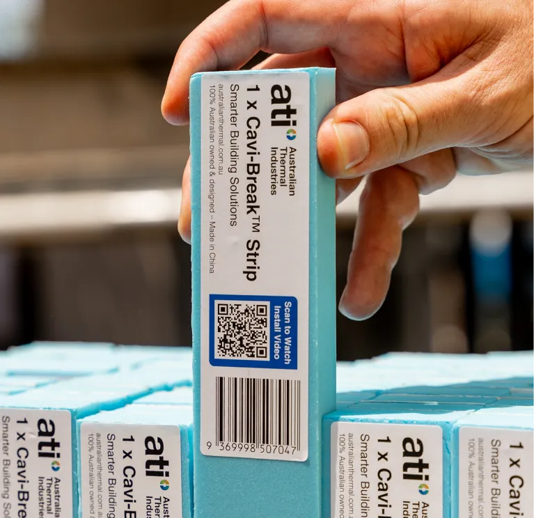 Hand holding a 1 x Cavi-Break strip by Australian Thermal Industries with a QR code for an install video.