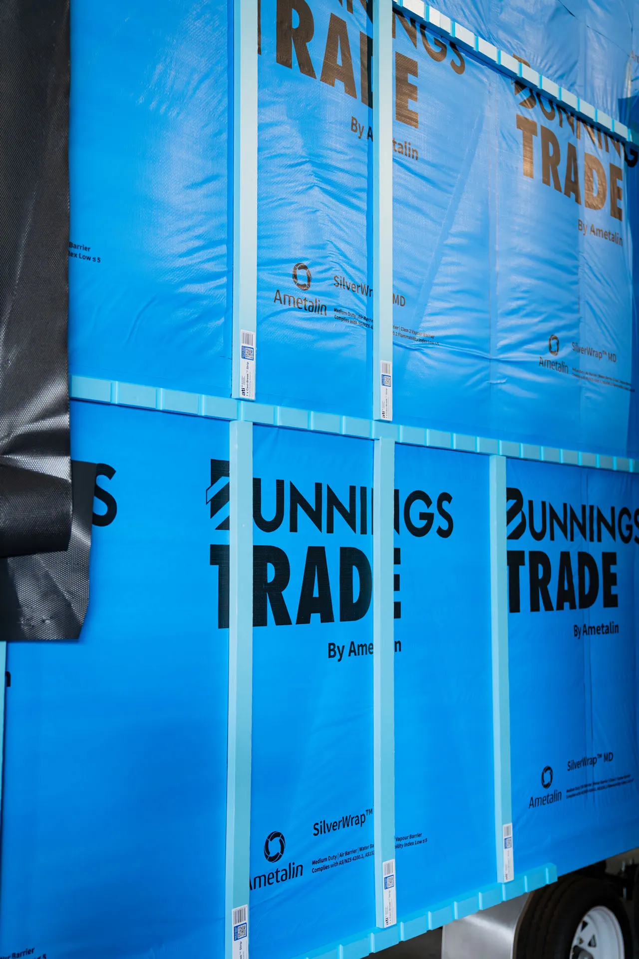 Blue Bunnings Trade SilverWrap packaging stacked and secured with blue strapping.