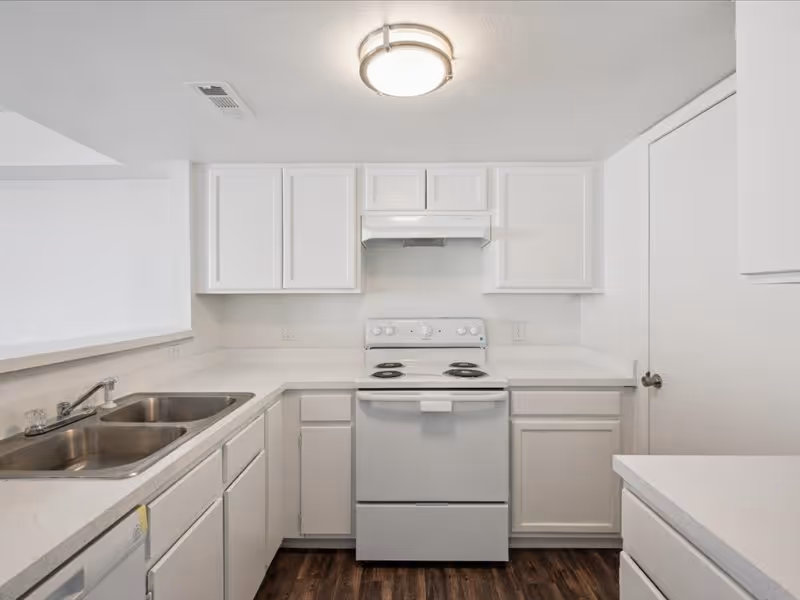 Kitchen with white cabinets and white appliances