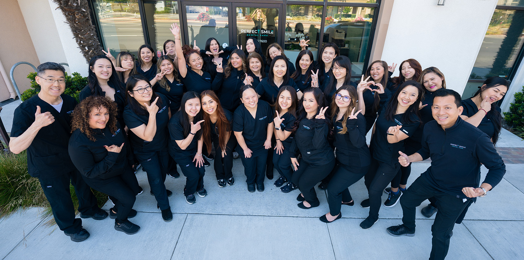 Full team photo in front of Perfect Smile Dental Care in Santa Clara, CA