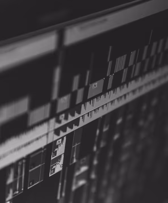 Close-up view of a computer screen showing a digital audio workstation interface with multiple audio tracks and waveforms.