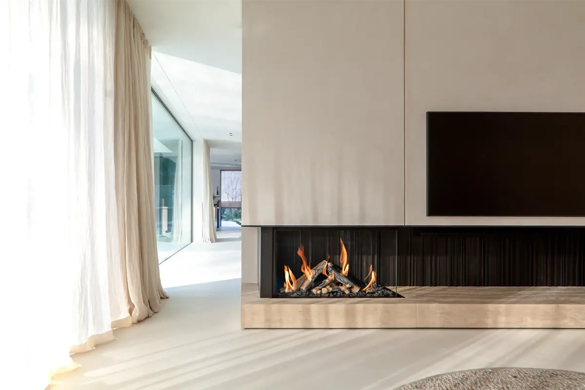 Modern living room with a wall-mounted TV and a gas fireplace with flames and logs.