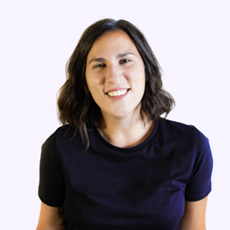 Smiling woman with shoulder-length dark hair wearing a plain black t-shirt against white background.