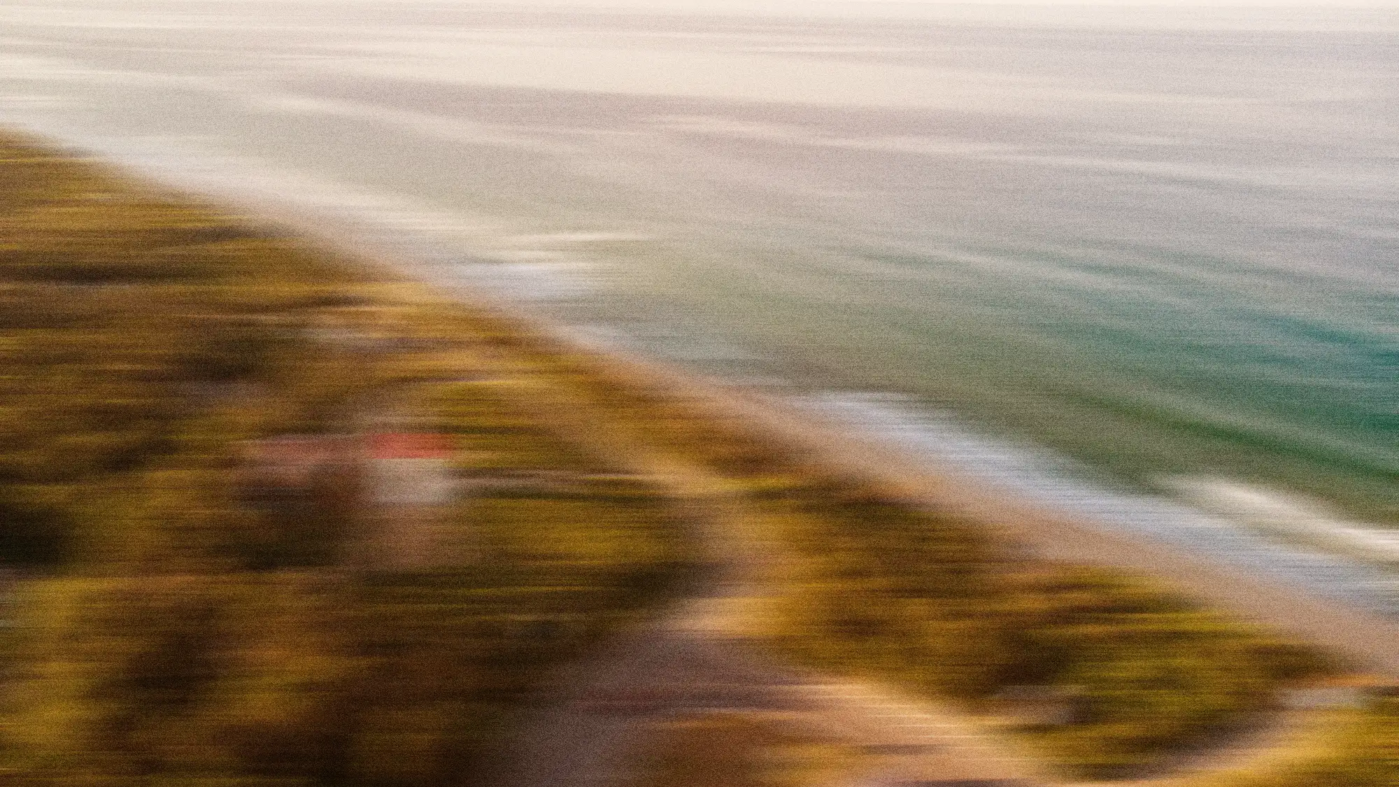 Blurred image of flying over a beach in a private jet.
